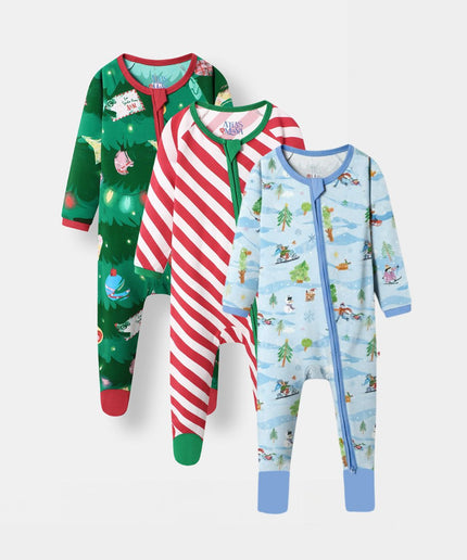 Three baby bamboo footed sleepers with full zippers, displayed in a three-by-one arrangement on a light gray background. The left sleeper is green with a Christmas tree and holiday print, the middle sleeper has red and white candy cane stripes, and the right sleeper is light blue with a winter ski and snow print.
