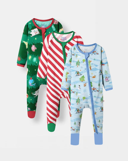 Three baby bamboo footed sleepers with full zippers, displayed in a three-by-one arrangement on a light gray background. The left sleeper is green with a Christmas tree and holiday print, the middle sleeper has red and white candy cane stripes, and the right sleeper is light blue with a winter ski and snow print.